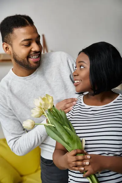 A smiling African American couple enjoys time together at home. — Stock Photo