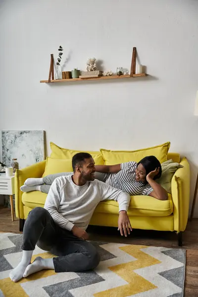 A loving African American couple laughs and enjoys each others company at home. — Stock Photo