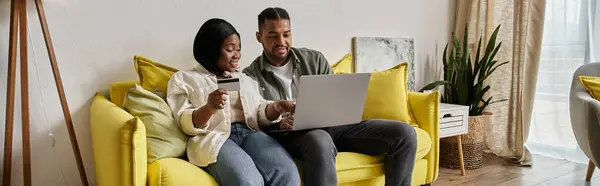 An African American couple enjoys an evening browsing the internet. — Stock Photo