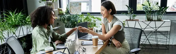 Two women partners work together at a desk in a modern office. — Stock Photo