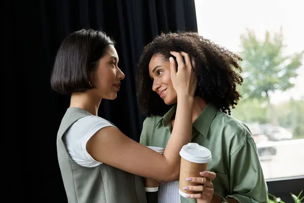 Two women in a lesbian couple bonding at work. — Stock Photo