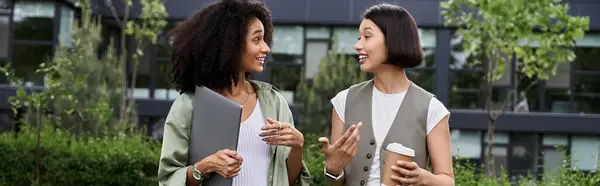 Two women, a loving couple, walk and talk outdoors. — Stock Photo