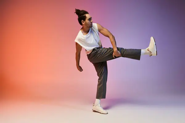 Un Afro-Américain danse sur un fond de dégradé coloré, mettant en valeur son mouvement dynamique et son énergie jeune. — Photo de stock