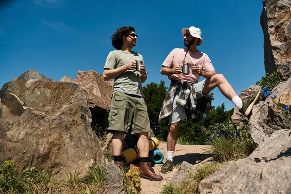 Two young men, a gay couple, are hiking in nature during the summer. — Stock Photo
