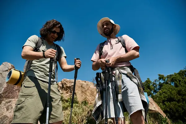 A happy gay couple enjoys a hike in the wilderness on a sunny summer day. — Stock Photo