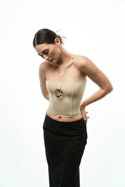 A young brunette woman showcases her exquisite jewelry, with a focus on a large, eye-catching pendant. — Stock Photo