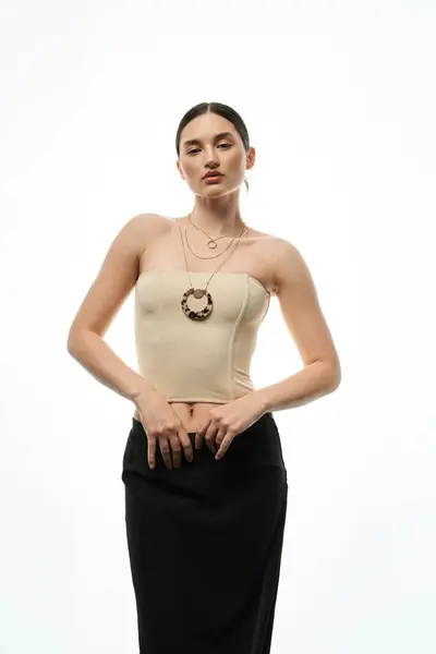 A young brunette woman with beautiful jewelry against a white backdrop. — Stock Photo