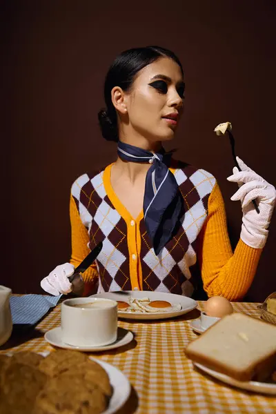 A young woman in a stylish sweater enjoys breakfast at a table. — Stock Photo