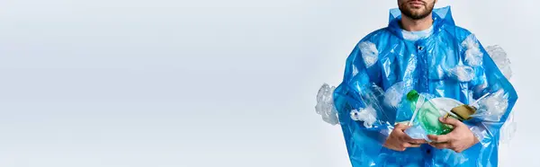 A man stands against a white backdrop, enveloped in a sea of plastic. — Stock Photo