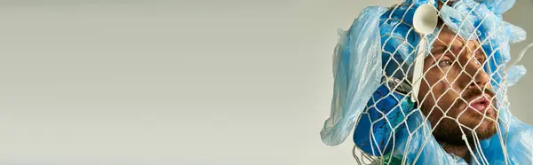 A man's face is obscured by plastic bags and a net. — Stock Photo