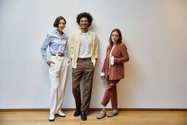 Three colleagues stand in a modern office, smiling and chatting. One woman wears a prosthetic leg. — Stock Photo