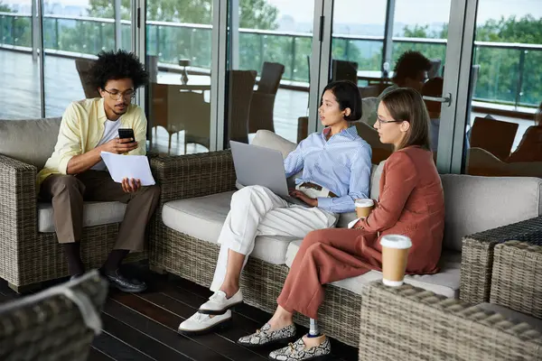 Three colleagues enjoy a relaxed conversation on a rooftop terrace. — Stock Photo