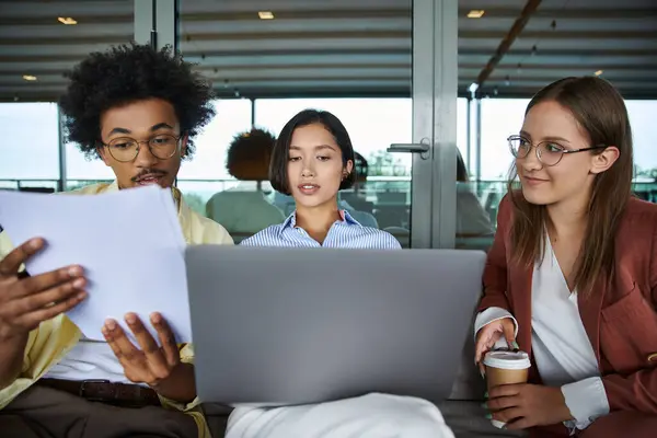 Interracial colleagues chat and work on a rooftop terrace — Stock Photo