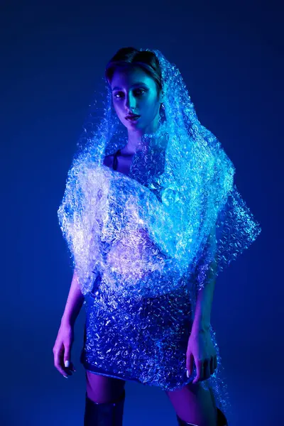 Woman models bubble wrap design in blue and purple light — Stock Photo