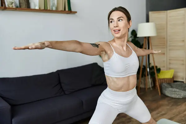 A young woman with vitiligo practices yoga in her apartment. — Stock Photo