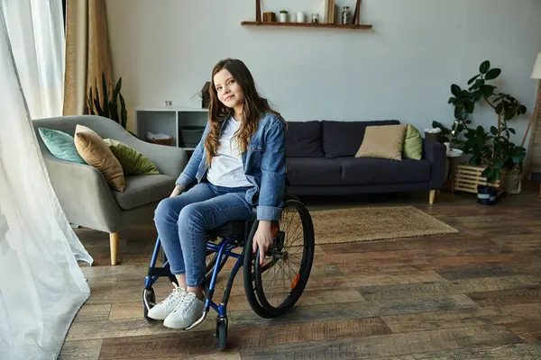 A young woman sits in her wheelchair, looking directly at the camera in her modern apartment. — Stock Photo