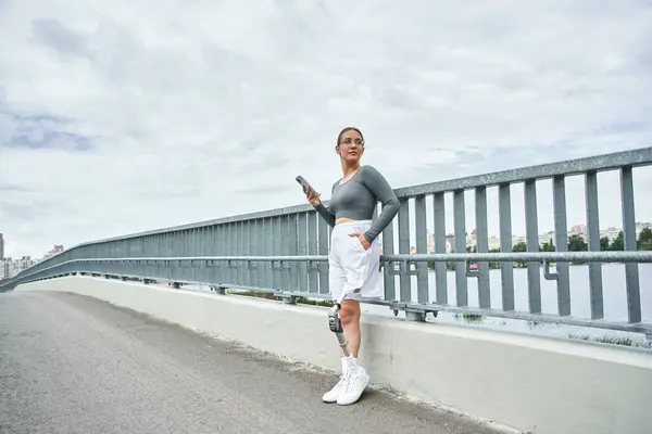 A determined young woman in sportswear exercises outdoors, embracing her strength and resilience. — Stock Photo