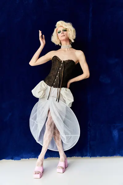 A dynamic young drag artist showcases stylish attire with flair and confidence. — Stock Photo