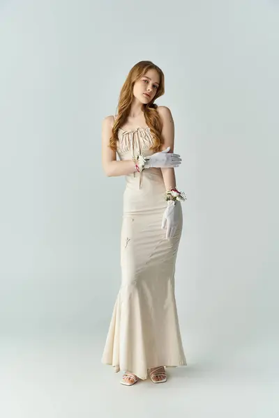 A graceful woman stands elegantly, delicate flowers on gloves. — Stock Photo