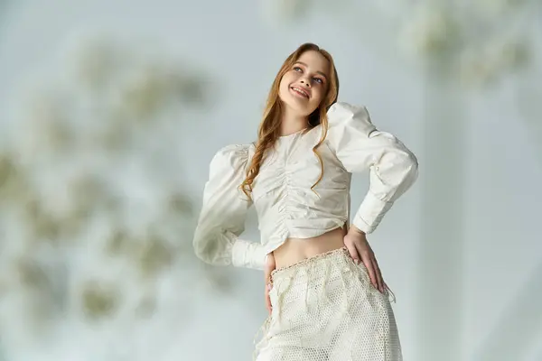 A cheerful young woman embraces nature surrounded by delicate blooms. — Stock Photo