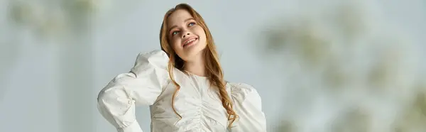 A joyful woman smiles, embracing the beauty of nature with vibrant flowers. — Stock Photo