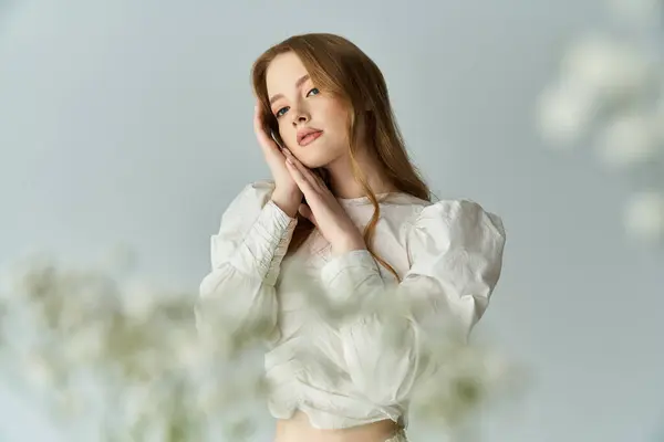 A beautiful young woman with flowers delicately framing her thoughtful expression. — Stock Photo