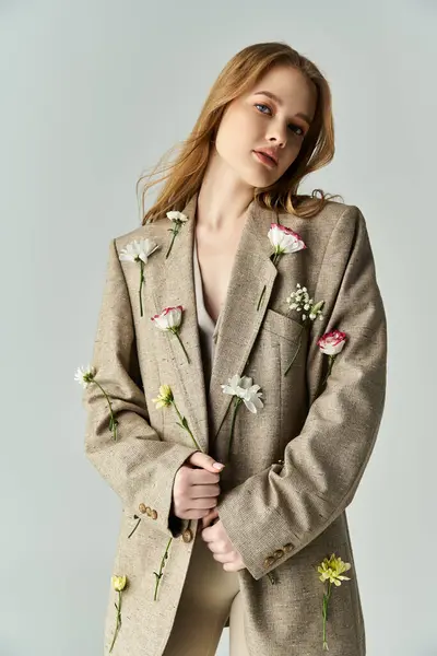 A beautiful young woman showcases floral details on her tailored outfit. — Stock Photo