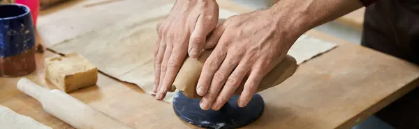 Talented man in apron making some pottery. — Stock Photo