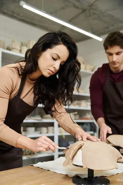 A couple joyfully molds clay in a bright, contemporary pottery studio. — Stock Photo