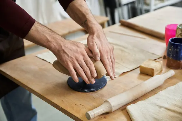 Ambitious man in apron making some pottery. — Stock Photo