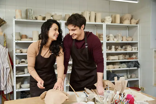 A couple enjoys creating pottery in a contemporary studio filled with art. — Stock Photo