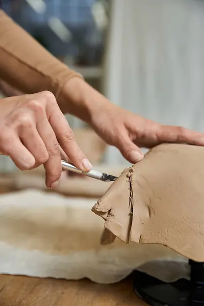 Dedicated woman making pottery in well lit studio. — Stock Photo