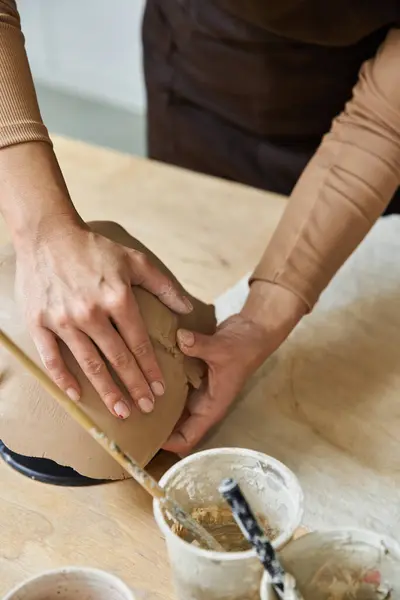 Ambitious woman making pottery in well lit studio. — Stock Photo