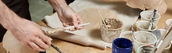 Hands of man who making pottery in well lit studio. — Stock Photo