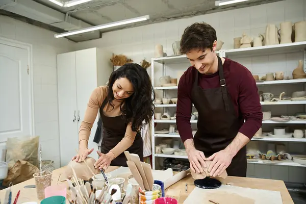 A couple joyfully creates pottery in a bright and inviting studio. — Stock Photo