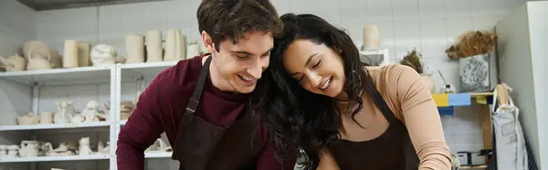 Couple joyfully collaborates on pottery in a contemporary workshop. — Stock Photo