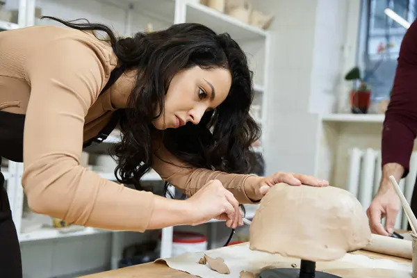 Dedicated appealing woman with long hair making pottery. — Stock Photo