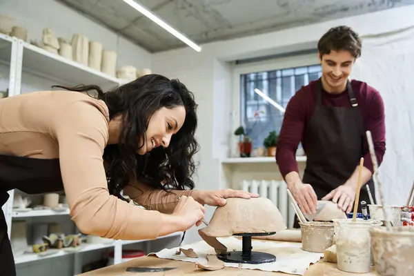 Una coppia forma gioiosamente argilla insieme in uno studio luminoso e invitante. — Foto stock