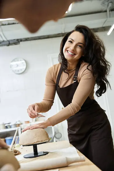Positive appealing man with dark hair making pottery. — Stock Photo