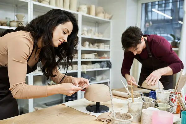 A couple joyfully crafts pottery together in a contemporary studio. — Stock Photo