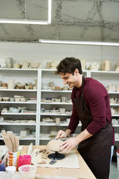 Talented good looking man with dark hair making pottery. — Stock Photo