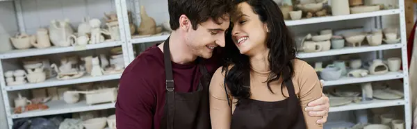 A couple joyfully collaborates on pottery in a contemporary workspace. — Stock Photo