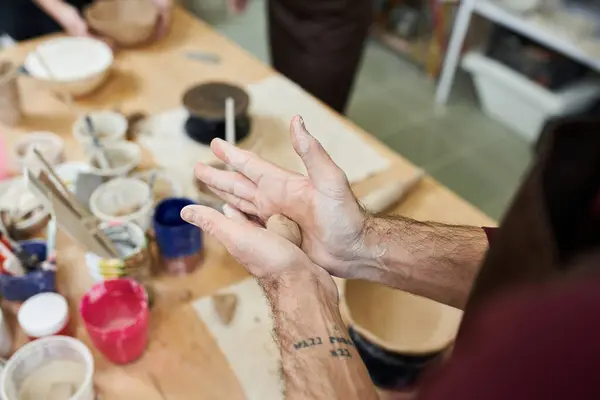 Hard working dedicated man with apron making pottery. — Stock Photo