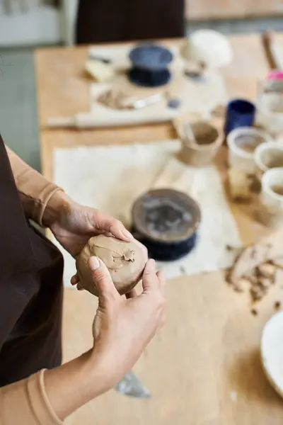 Talented woman with accessories and apron making pottery. — Stock Photo