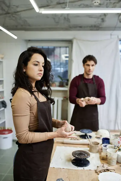 A couple enjoys crafting pottery in a stylish studio filled with creativity. — Stock Photo