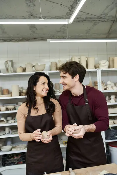 A couple joyfully shapes clay in a contemporary pottery workshop. — Stock Photo