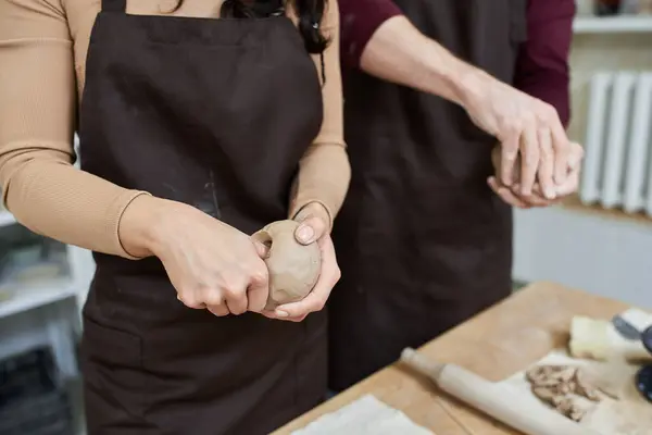 A couple enjoys crafting unique pottery in a bright, modern studio. — Stock Photo