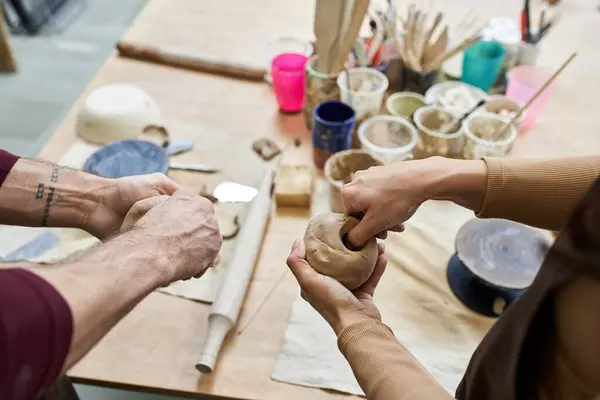 A couple shares creativity and joy while making pottery. — Stock Photo