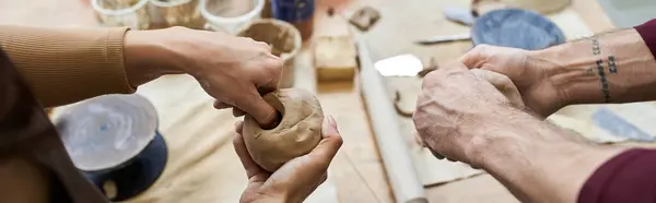 Loving partners shape clay into art in a bright, contemporary workspace. — Stock Photo