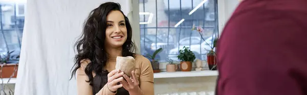 A couple shares a moment while shaping clay in a contemporary workshop. — Stock Photo